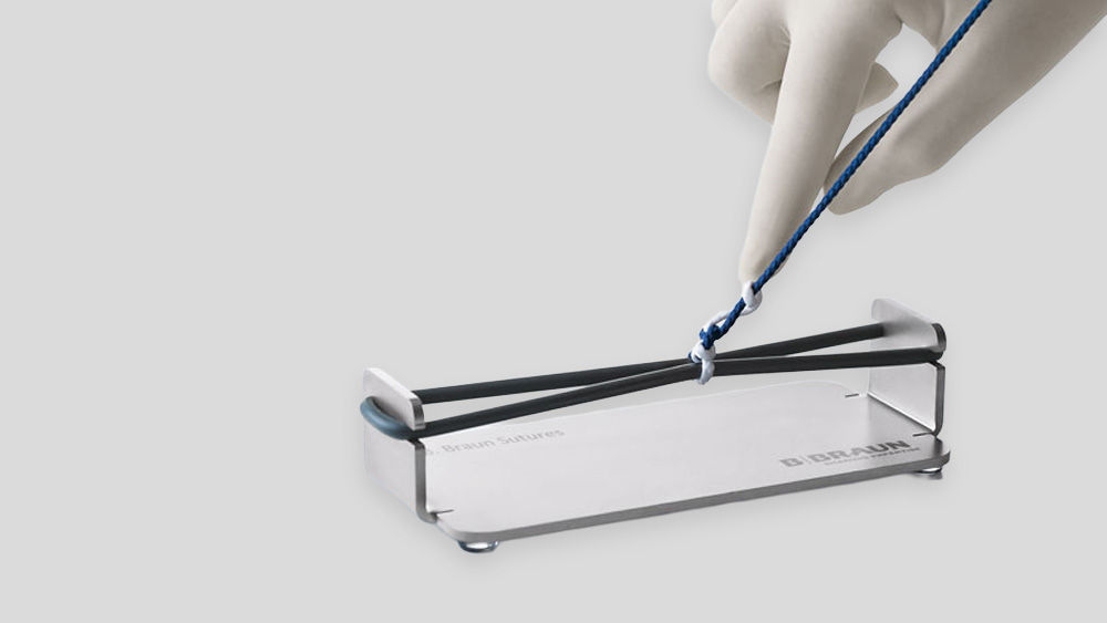 Vet making a surgical knot in the knot bank 