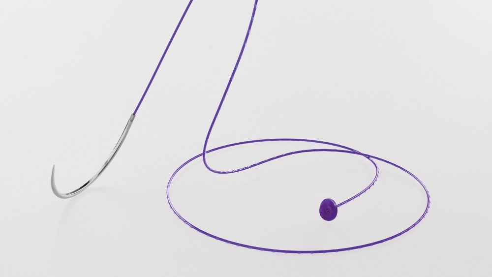 Close-up of the Symmcora knotless veterinary suture in purple, showing the curved surgical needle and the attached knotless button against a clean white background.