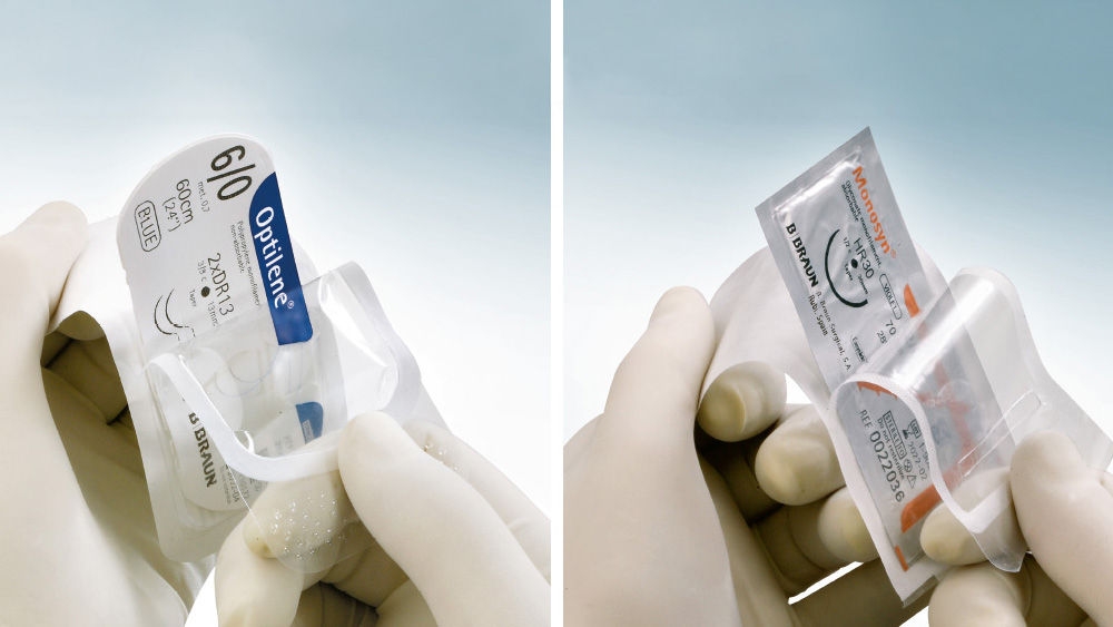 Two gloved hands holding suture packages in clear blister packaging, shown side by side. The left package is labeled Optilene® 6/0, blue, 60 cm, and the right package is labeled Monosyn®, both with B. Braun branding, against a light blue background.