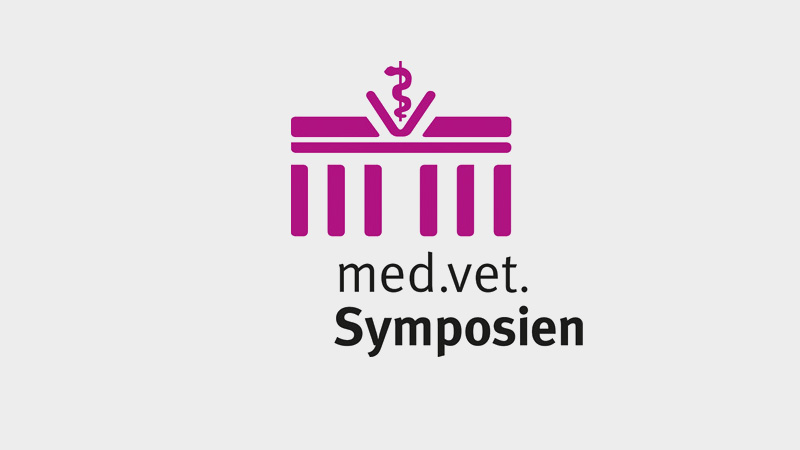 Logo featuring a stylized magenta veterinary symbol above a column-like design, with the text “med.vet. Symposien” below it.