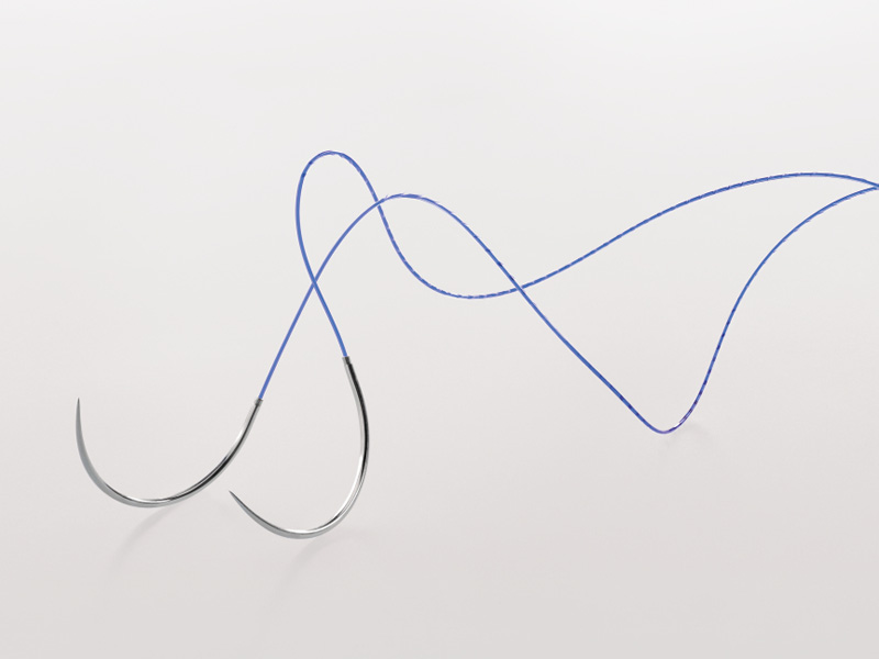 Close-up of the Symmcora knotless veterinary suture in purple, showing the curved surgical needle and the attached knotless button against a clean white background.