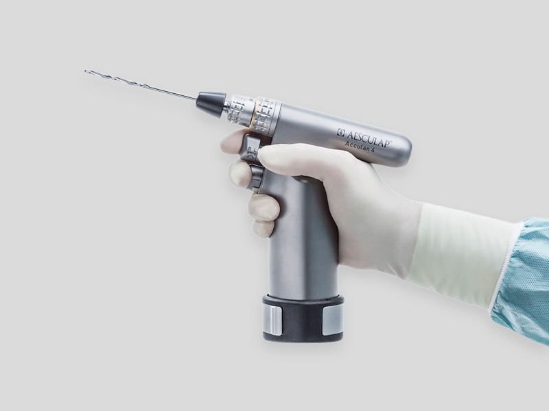 Acculan® 4 surgical power system with multiple handpieces, attachments, and accessories arranged on a white background.