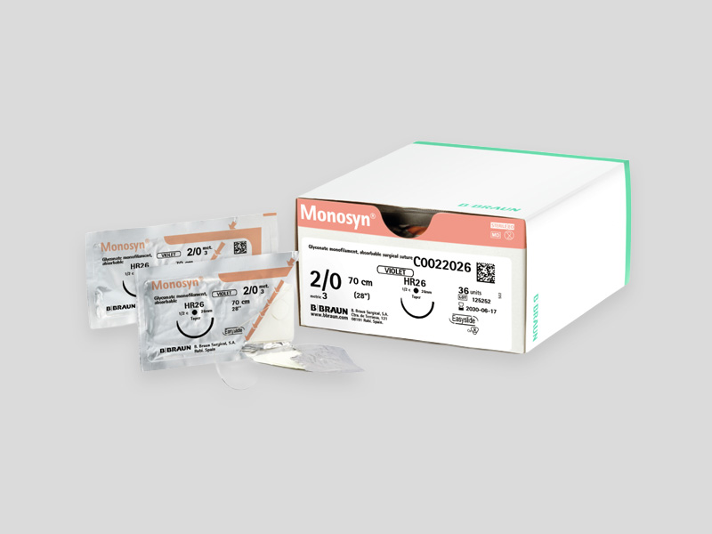 Monosyn® absorbable surgical suture with a curved needle and violet monofilament thread, isolated on a light background.